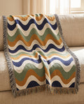 Tide throw draped over a linen sofa
