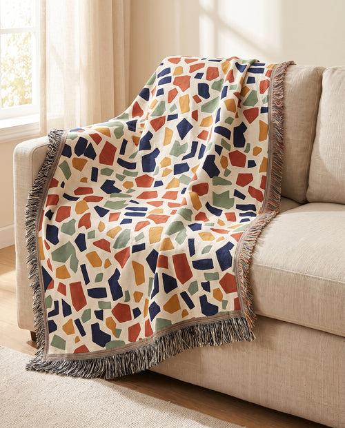 Terrazzo throw draped over a linen sofa